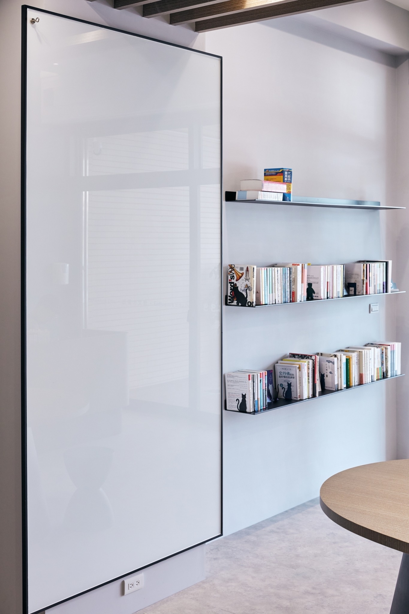 Whiteboard and reading shelves in the first-floor learning area